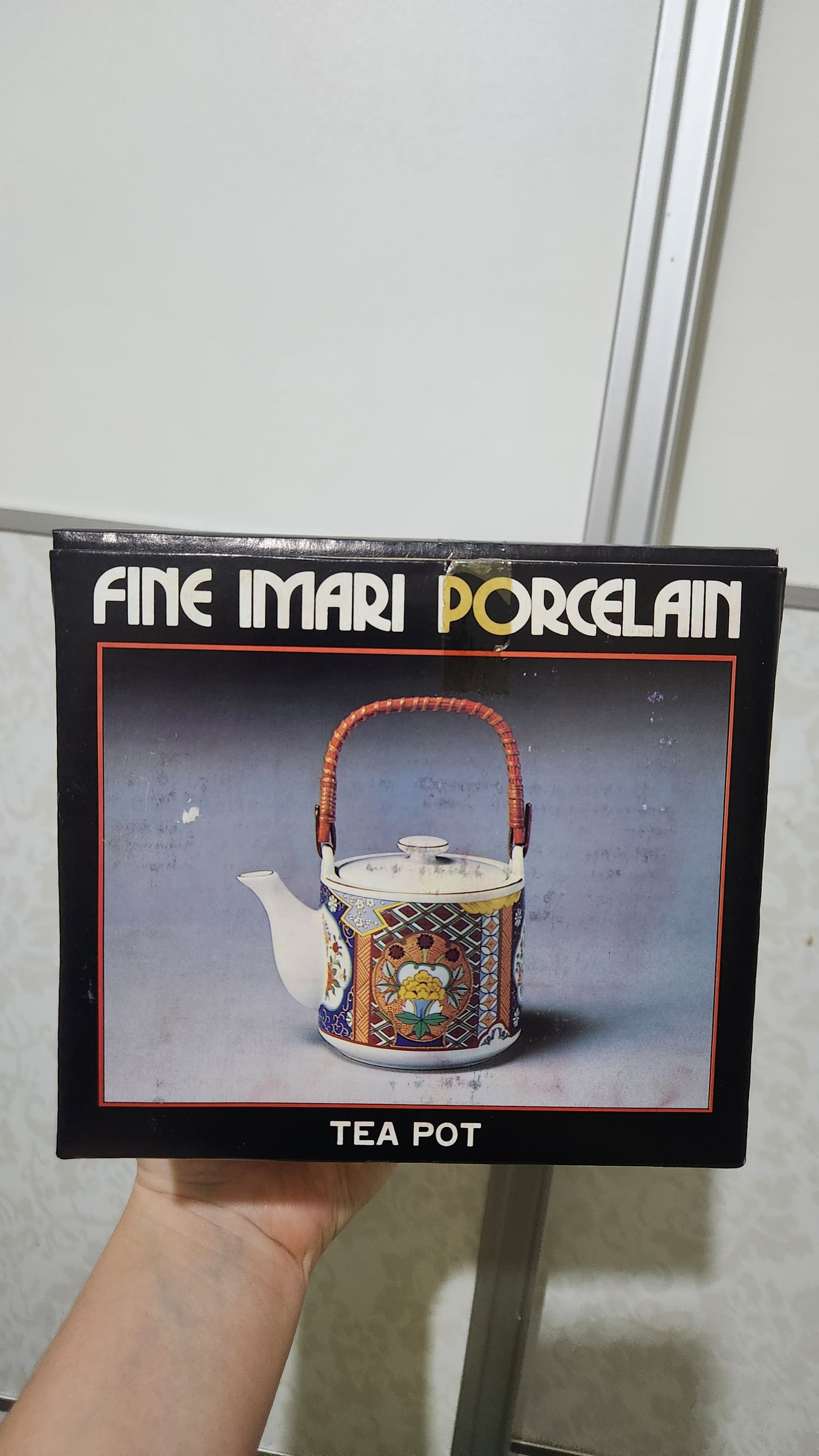 Vintage Japanese Imari ware porcelain teapot with a wicker handle