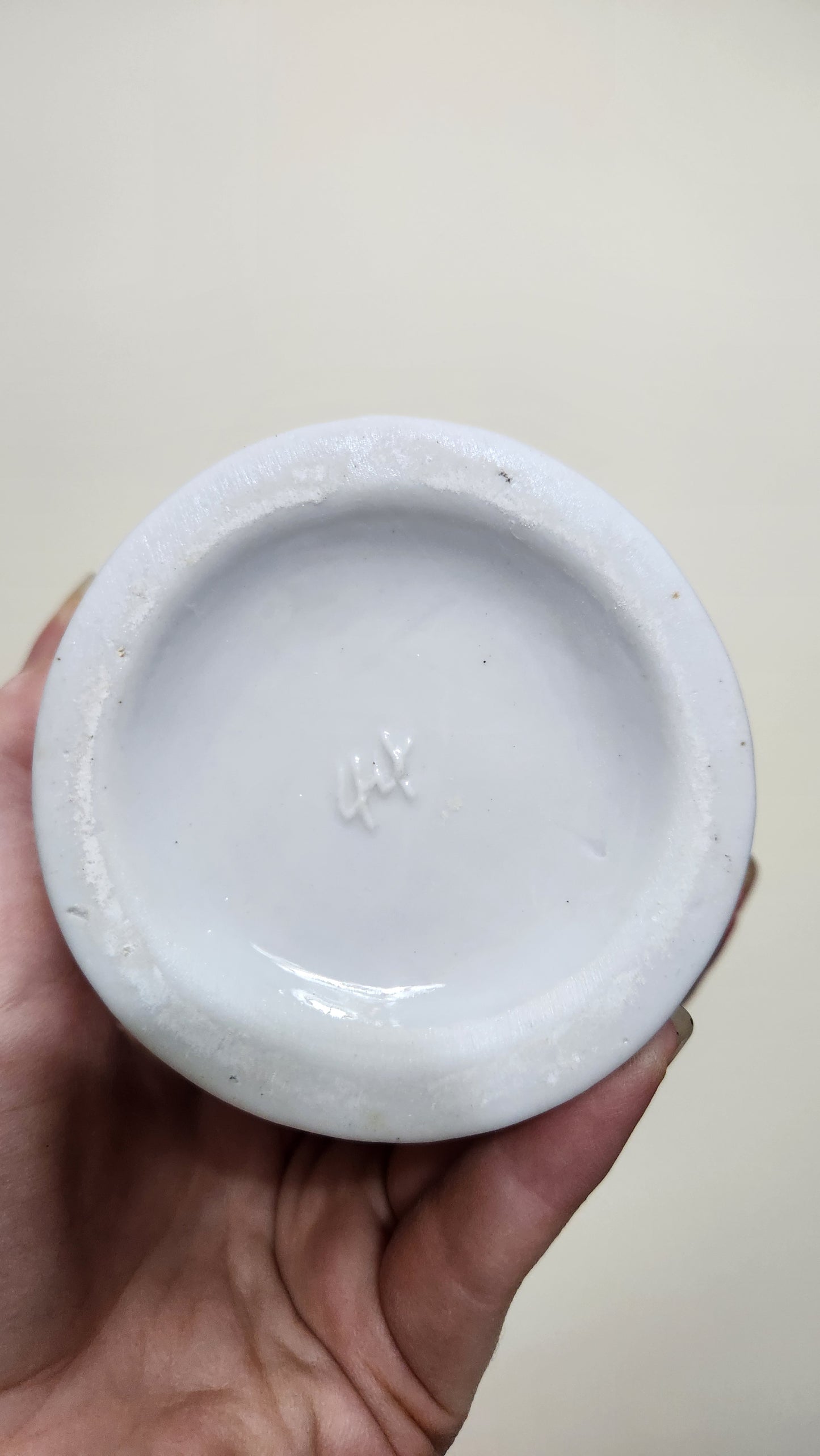 vintage porcelain vase with a floral design and a fluted spiral shape