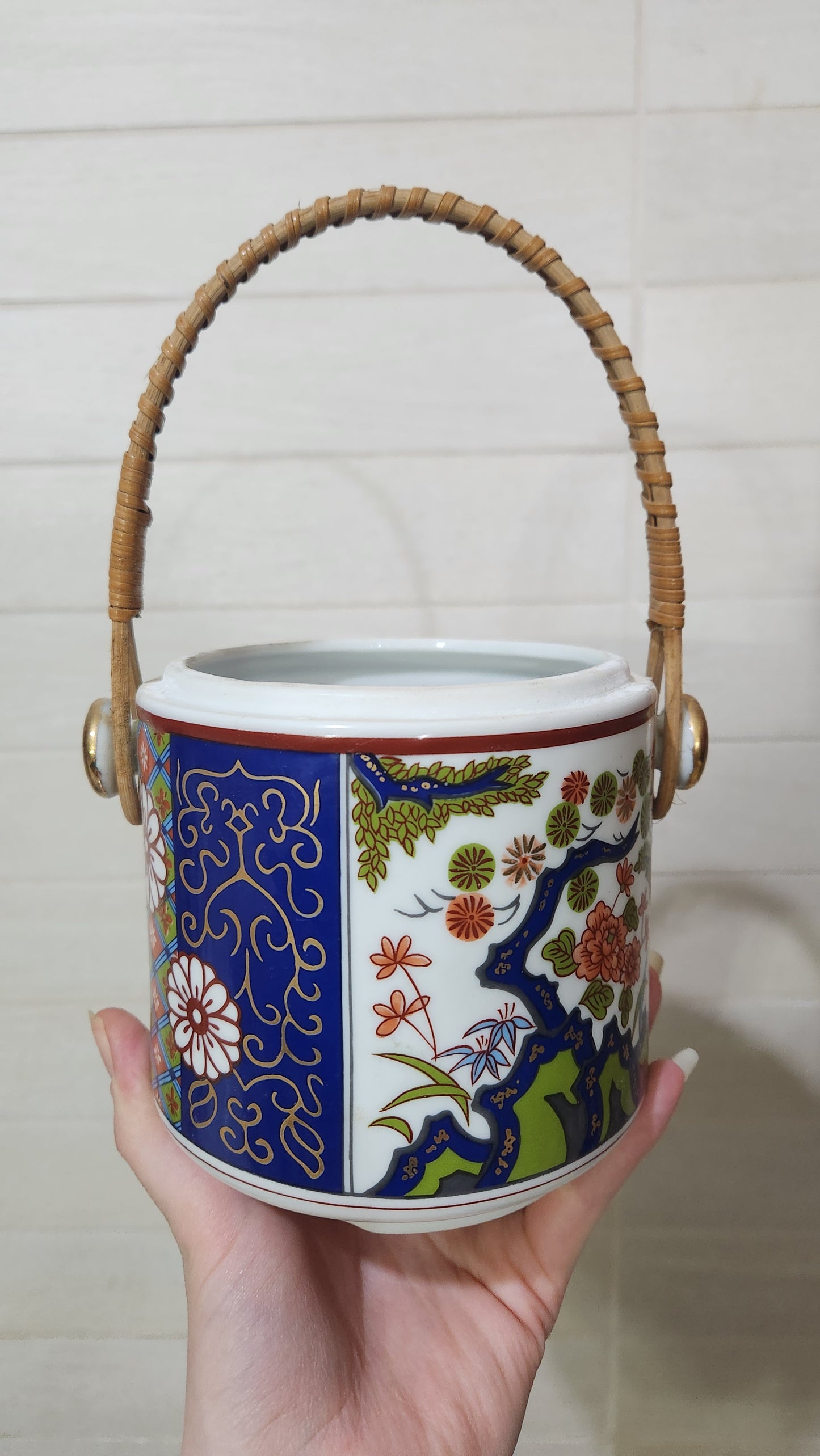 Vintage Japanese Imari-style porcelain teapot with a wicker handle