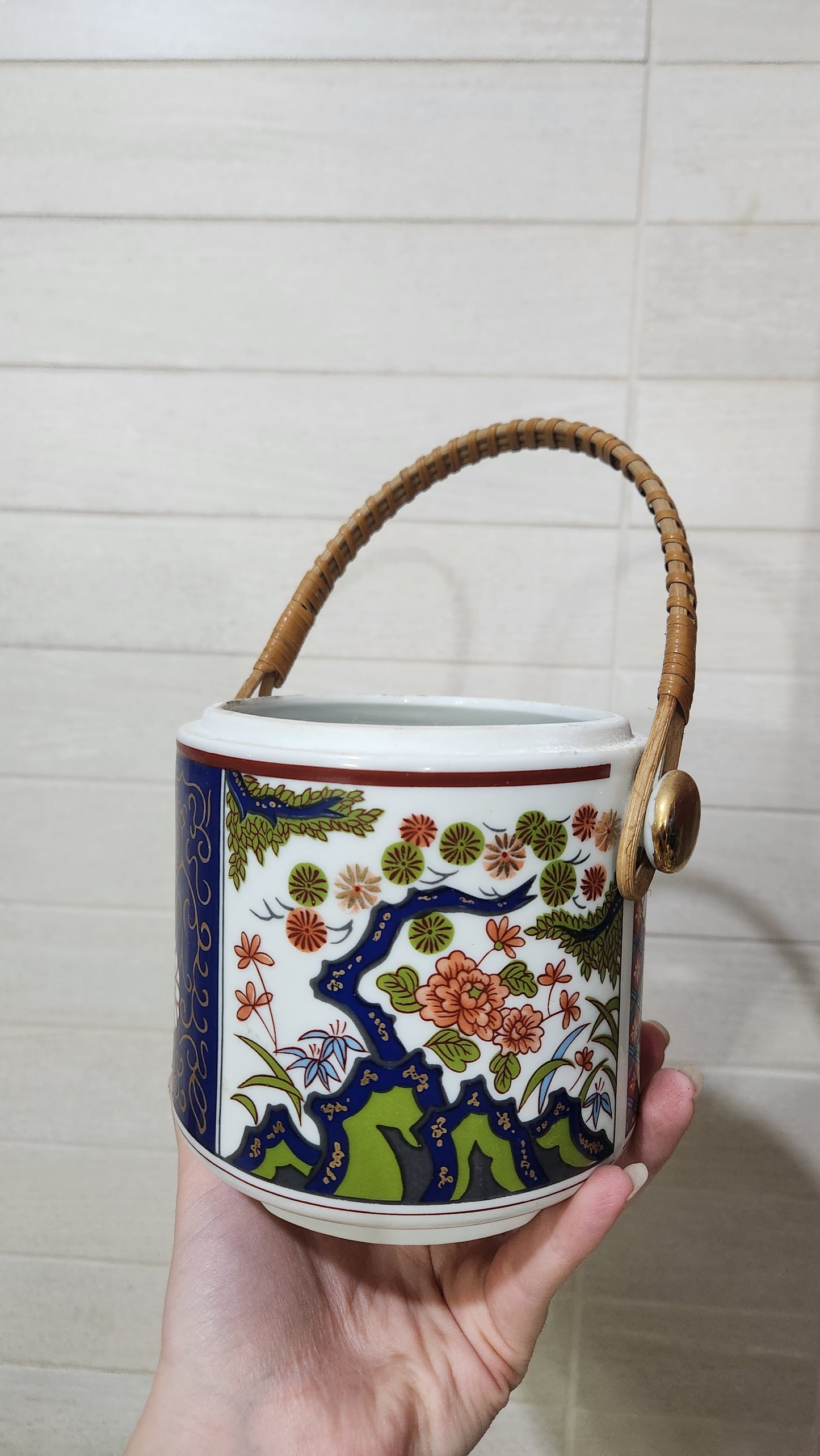 Vintage Japanese Imari-style porcelain teapot with a wicker handle