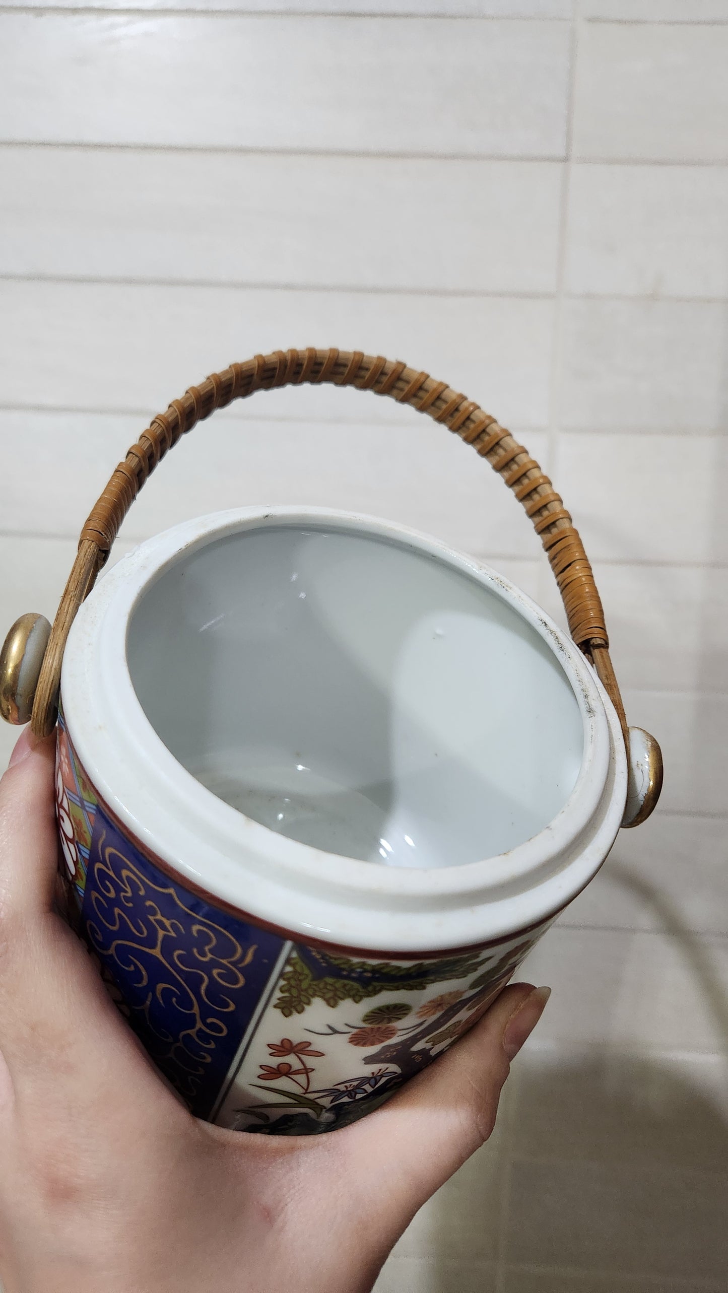Vintage Japanese Imari-style porcelain teapot with a wicker handle