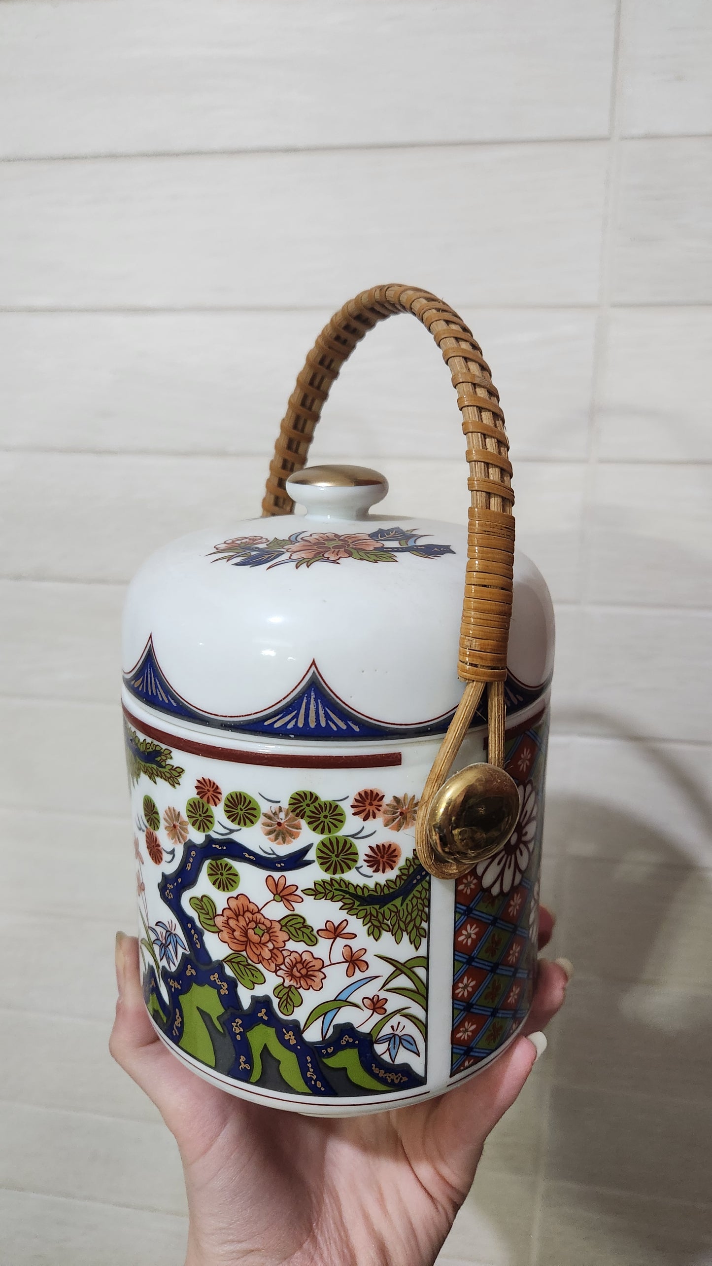 Vintage Japanese Imari-style porcelain teapot with a wicker handle