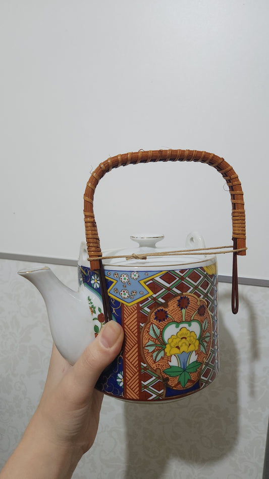 Vintage Japanese Imari ware porcelain teapot with a wicker handle