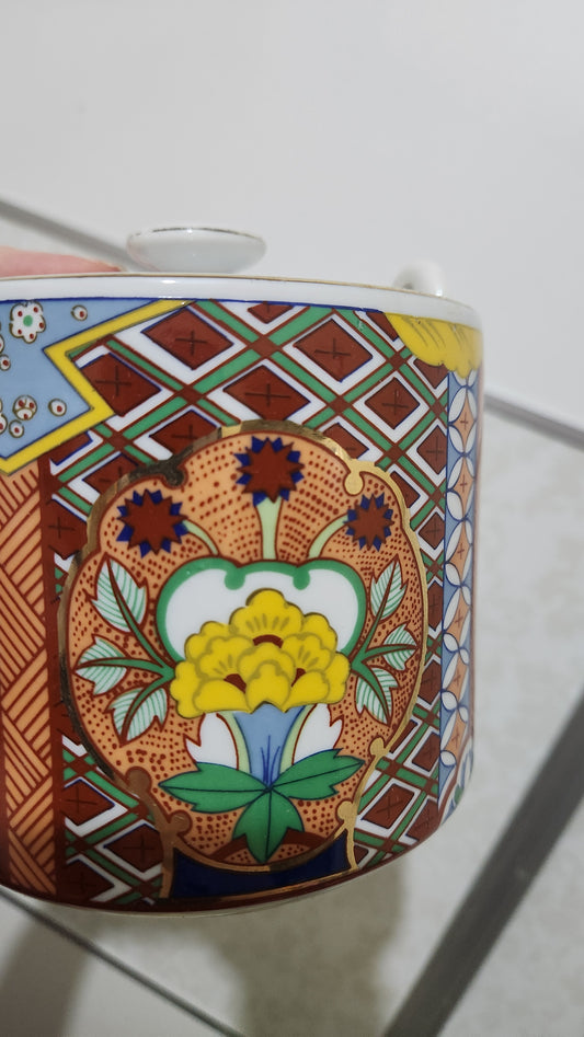 Vintage Japanese Imari ware porcelain teapot with a wicker handle