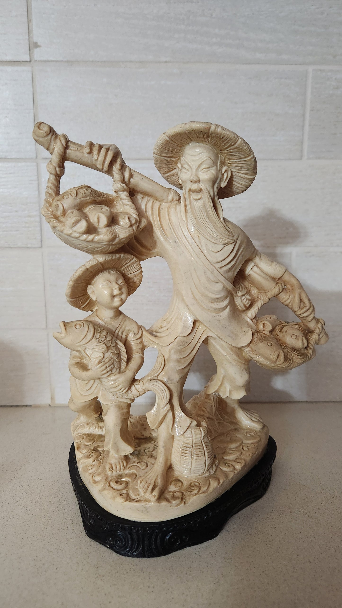 Faux Ivory Resin Figurine of an Oriental Fisherman and Boy with Catch